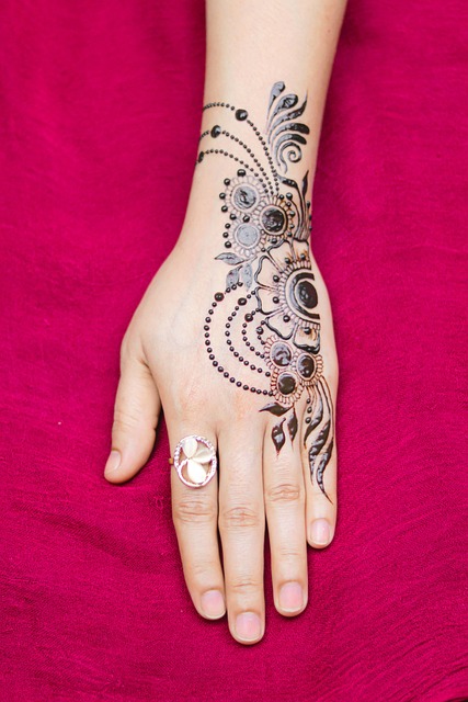 Blackwork tattoo artist working on geometric design